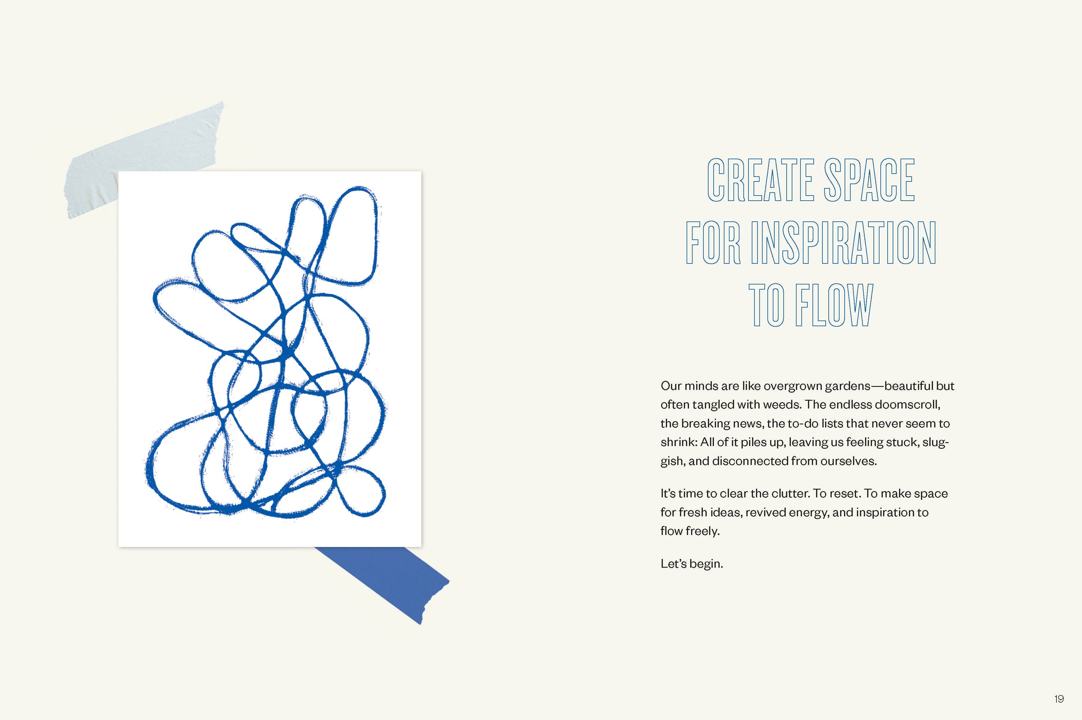 The Daily Creative journal next to a sheet of white paper with blue scribbles.