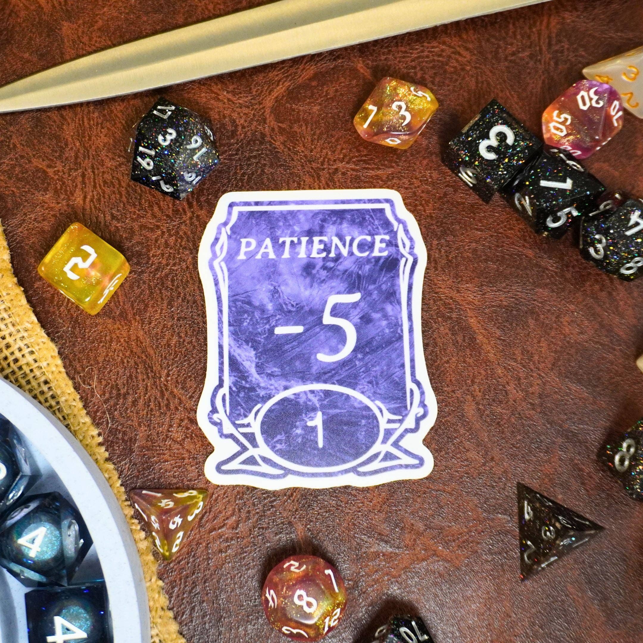 Purple Patience -5 Sticker displayed with colorful dice on a brown leather surface.