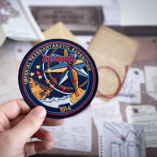 Imperial Trans-Antarctic patch held over documents for Shackleton Series: Escape Game based on a true story.
