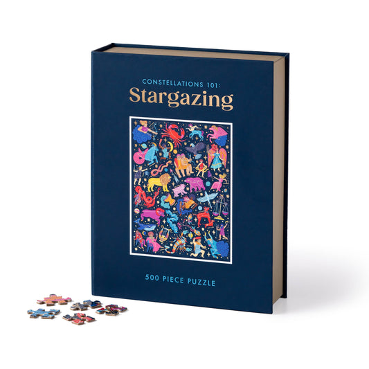 Constellations 101: Stargazing 500-piece puzzle box with constellation art and several loose puzzle pieces.