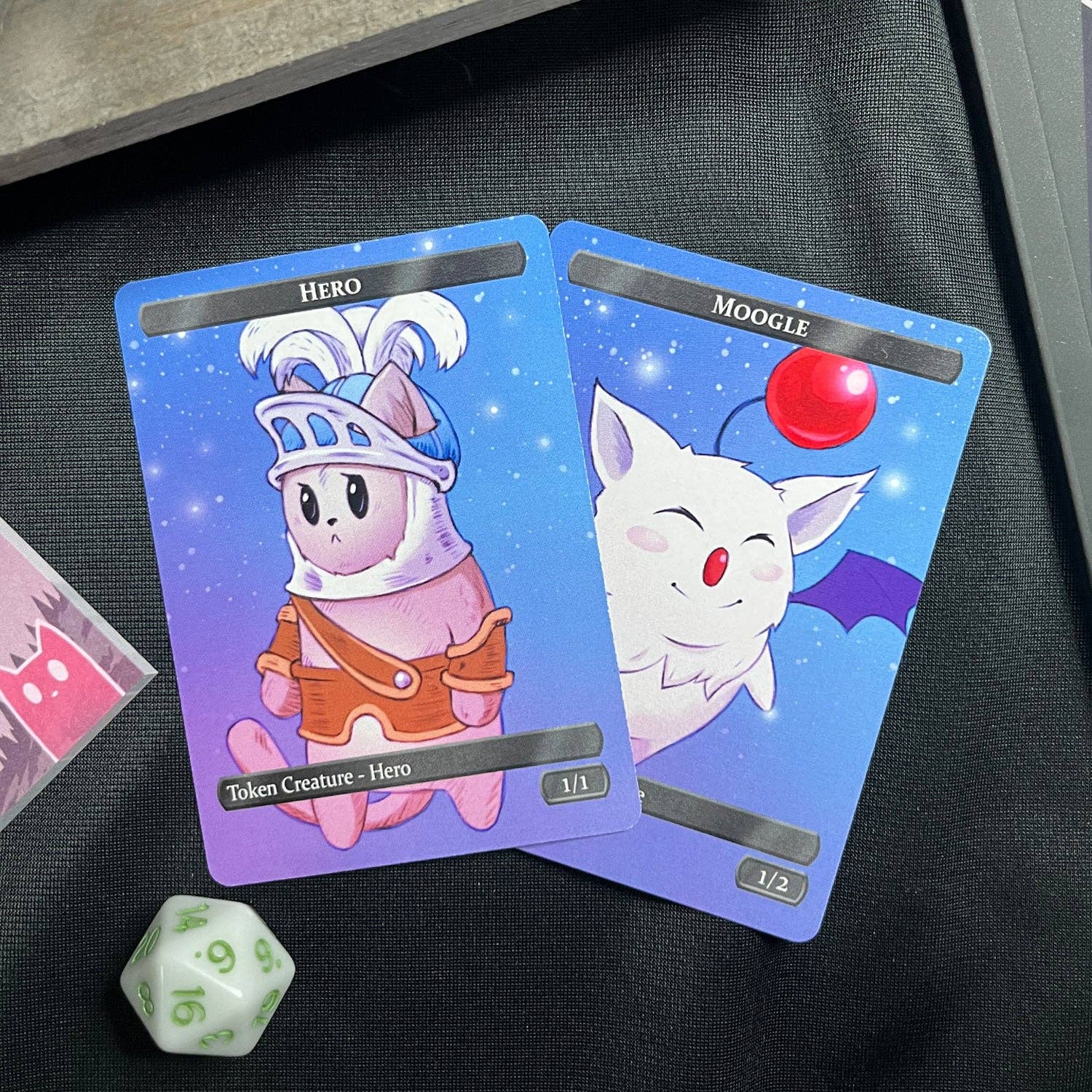 Hero Token Set with two illustrated trading cards and a white 20-sided die.