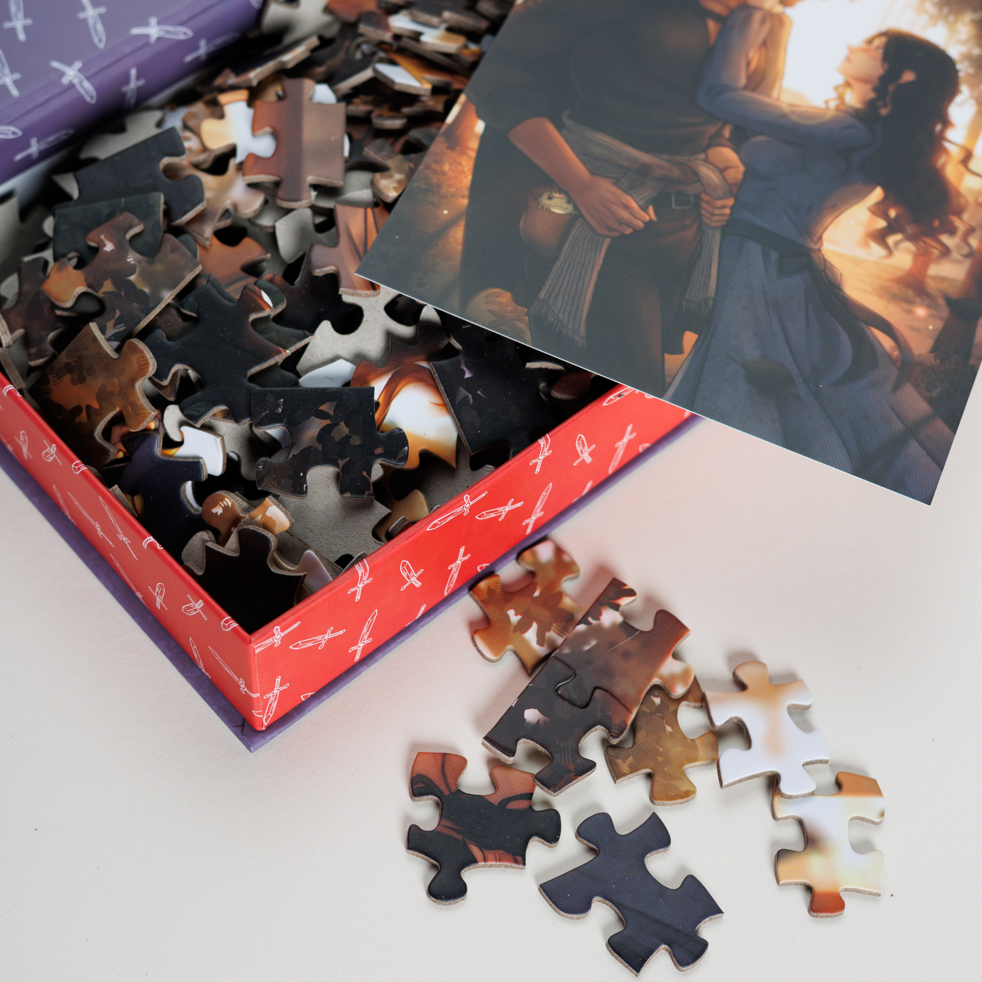 Evie & Villain Keepsake Puzzle in book-shaped box with scattered pieces and a couple embracing on the lid.