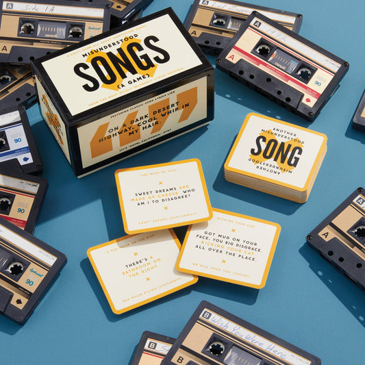 Misunderstood Songs Game box and cards featuring misheard lyrics.