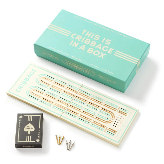 Cribbage in A Box game set with teal box, wooden board, playing cards, and pegs.
