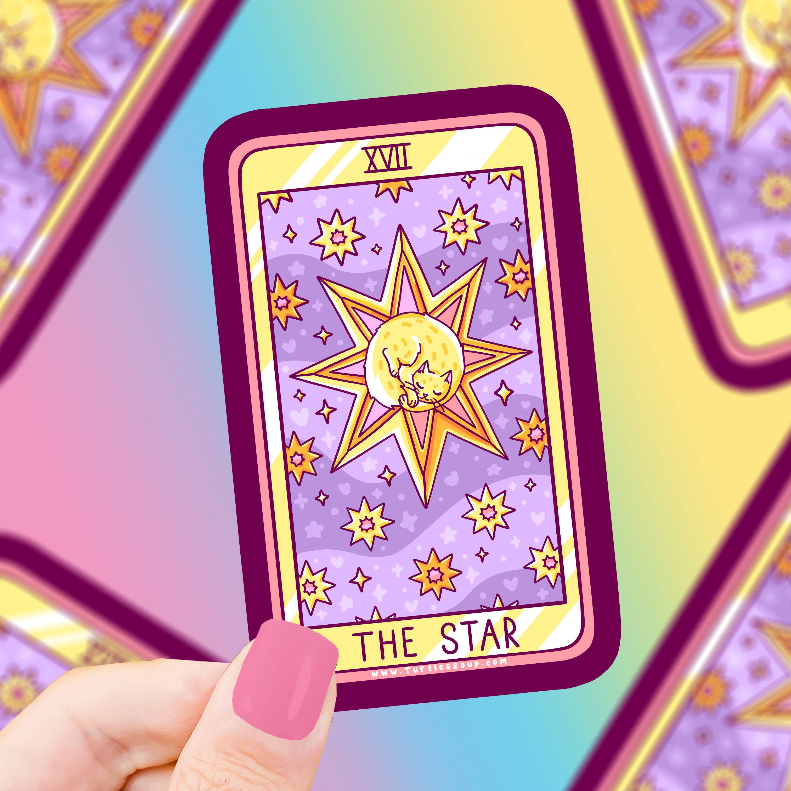 The Star Cat Tarot Card on an eco-friendly vinyl sticker held by a hand with pink nails.