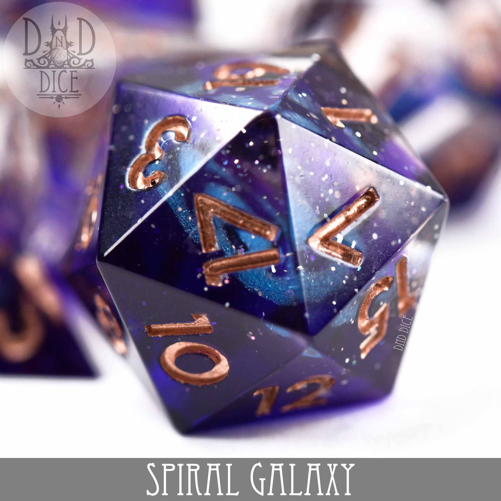 Spiral Galaxy Handmade 20-sided resin die with blue, purple, and black galaxy design and gold numbers.