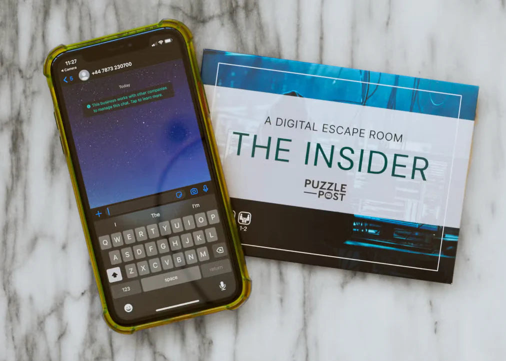 Interactive Escape Room - the Insider game booklet and smartphone displaying the game interface.