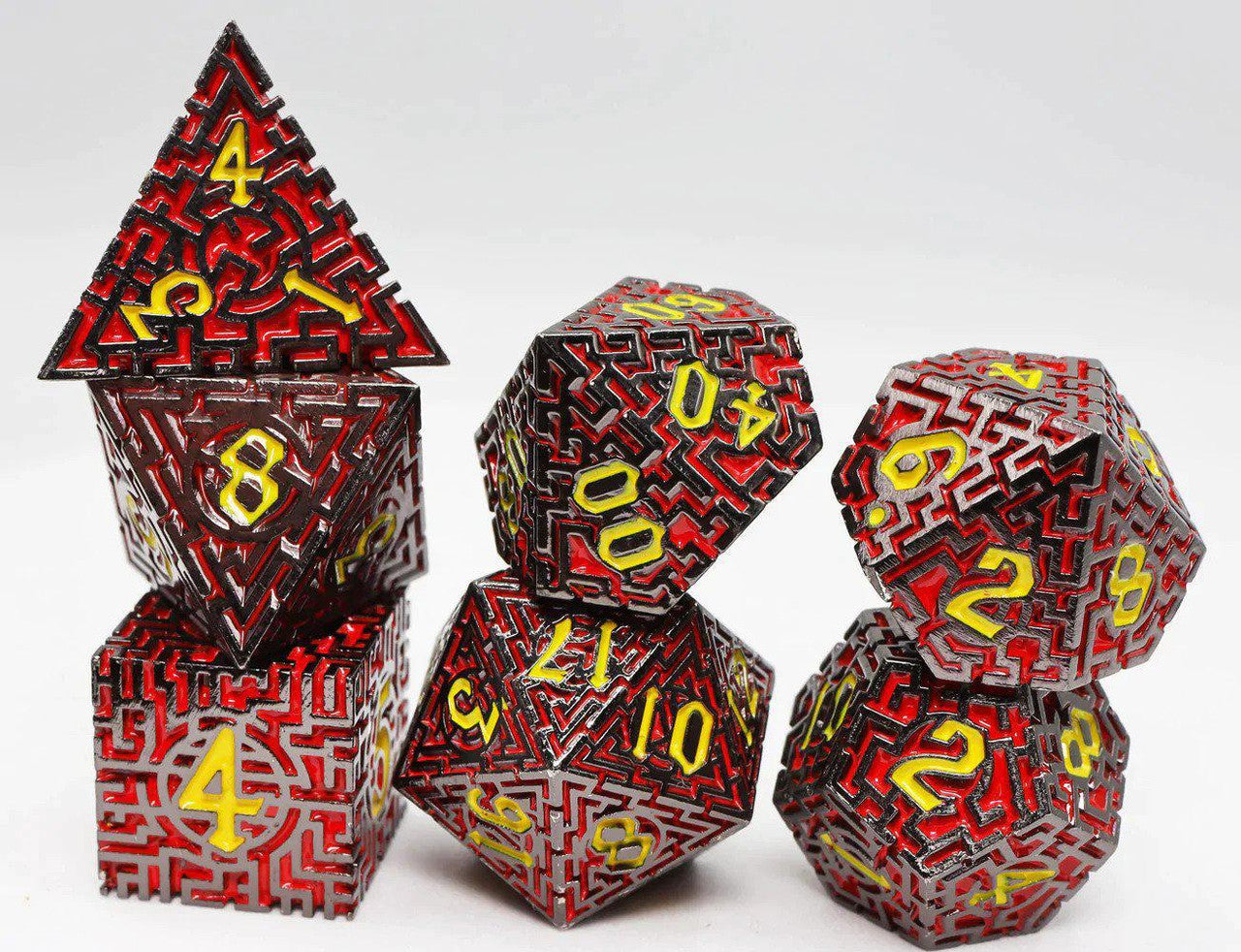 Daedalus Labyrinth RPG Metal Dice Set: 7 red and black polyhedral dice with yellow numbers.