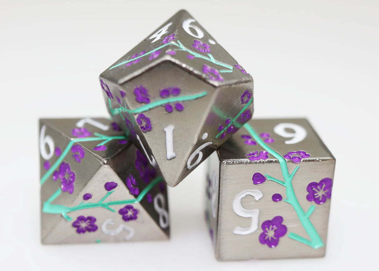 Metallic Bouquet: Silvered Jackmanii Metal RPG Dice Set featuring purple flower dice with green stems on white surface.