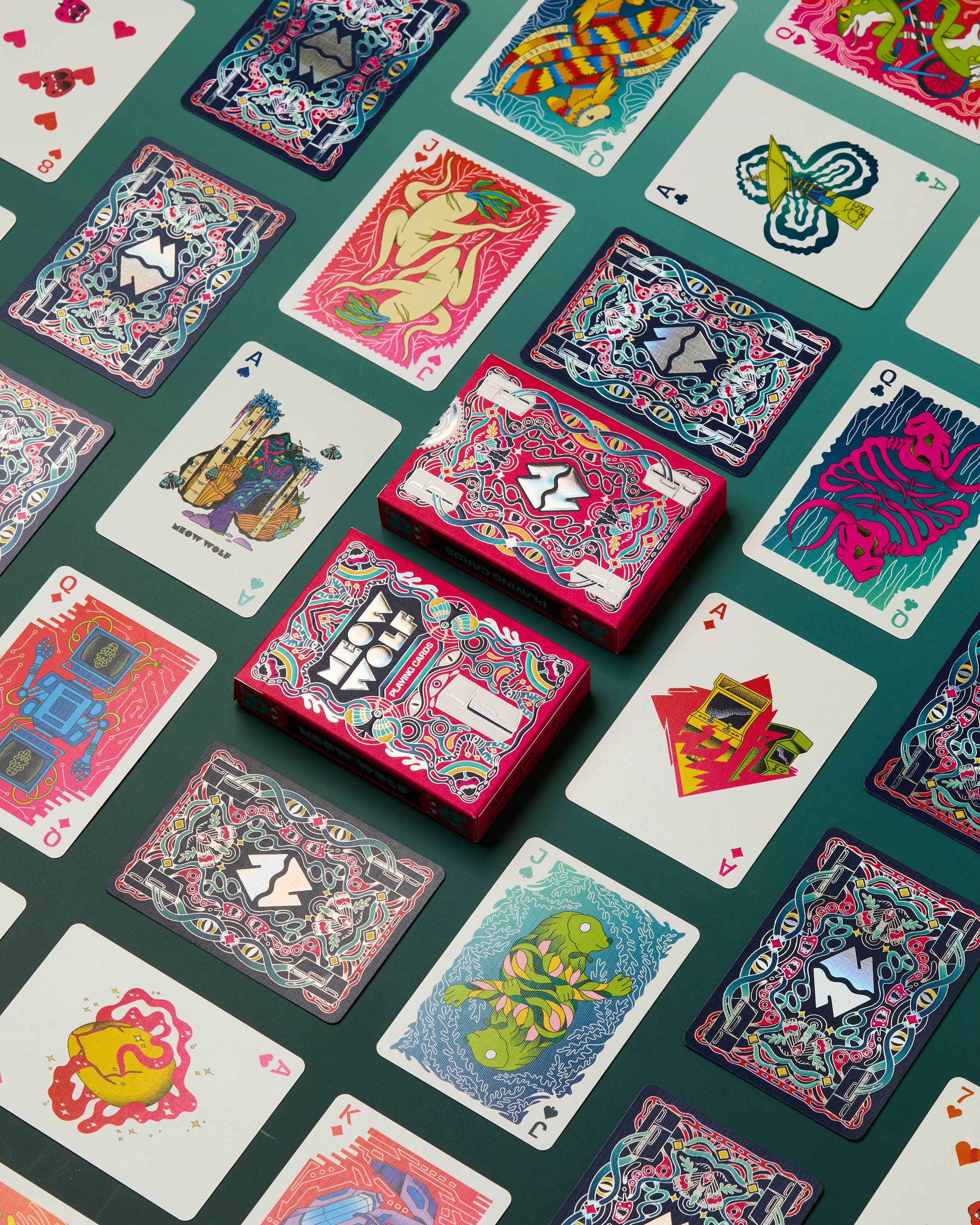 Meow Wolf playing cards in a patterned box with individual cards displayed.