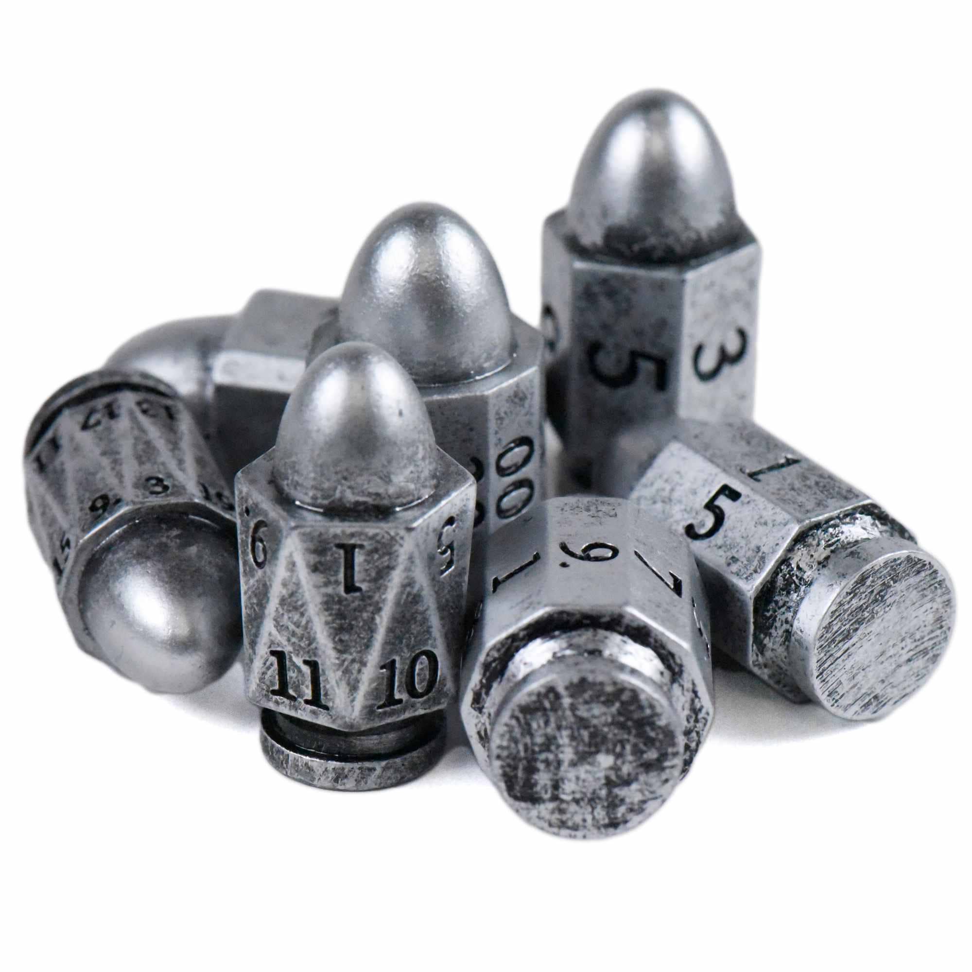 7-piece metal polyhedral dice set with bullet-shaped design and engraved numbers for tabletop gaming.