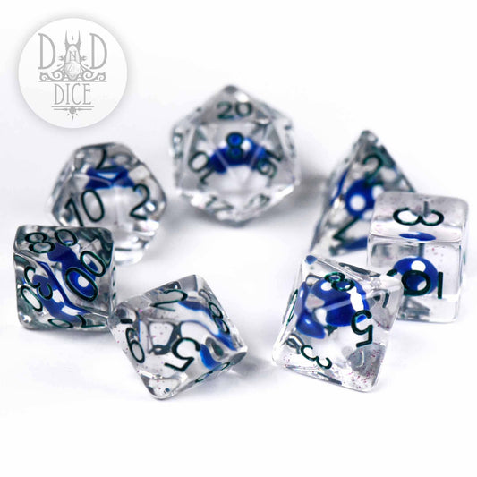 “Fungal Spores” 7-dice DnD set, clear resin with blue swirls and numbers, on white surface.