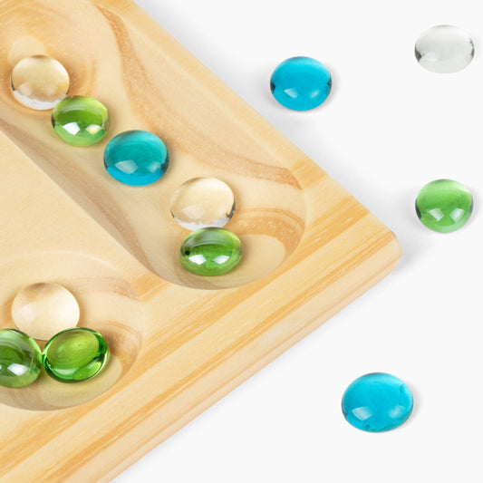 Canvas Classics Mancala folding wooden board with blue, green, and clear stones.
