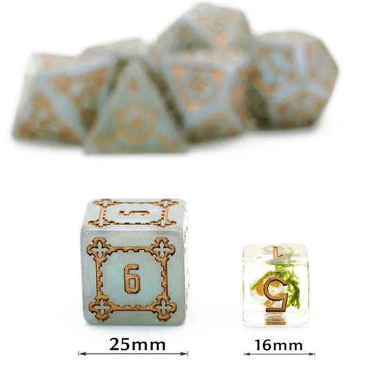 Huge gray Castle dice (25mm) with gold details in focus; clear green die and other dice blurred in background.