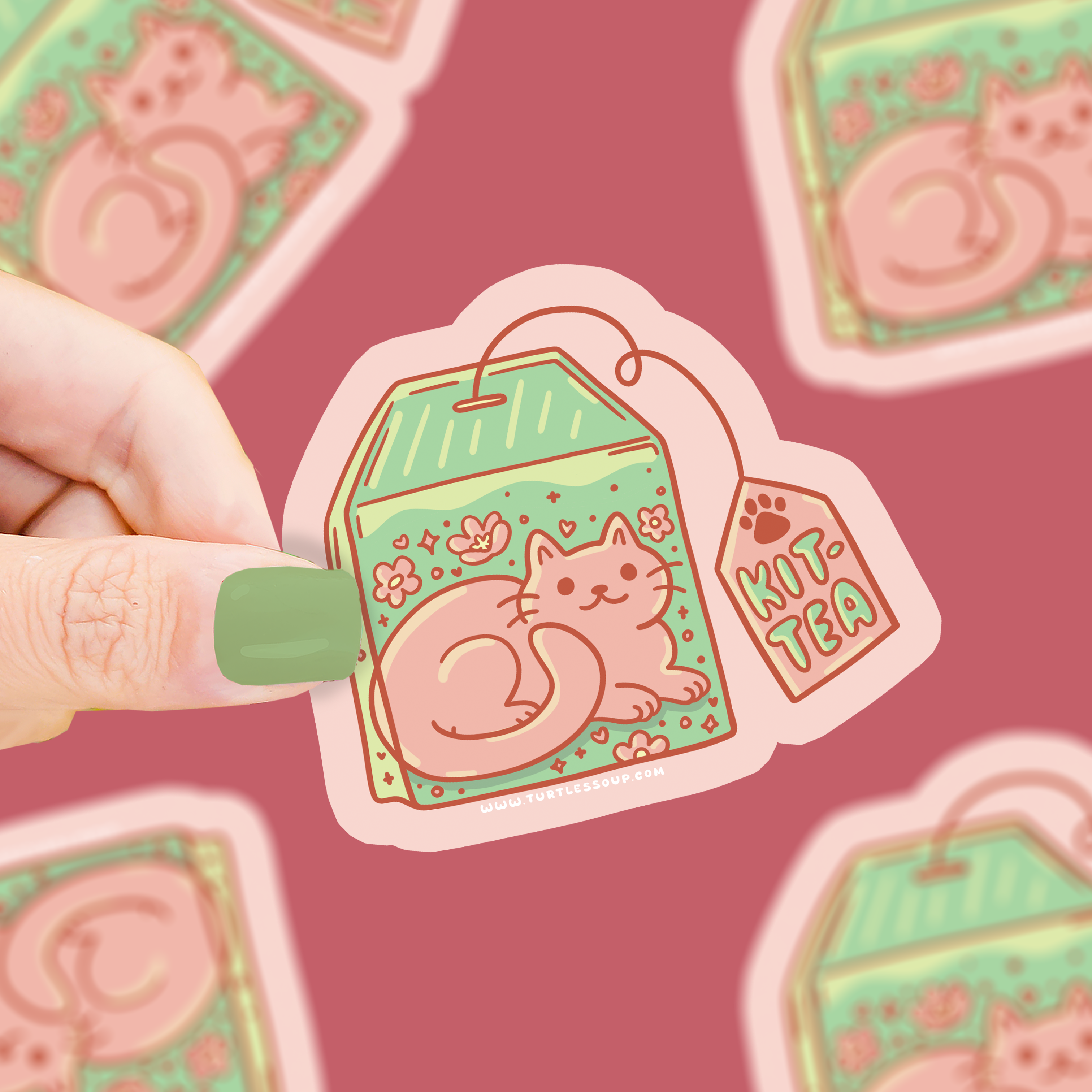Kittea Teabag vinyl sticker featuring a cat in a teabag with florals, held by a hand.