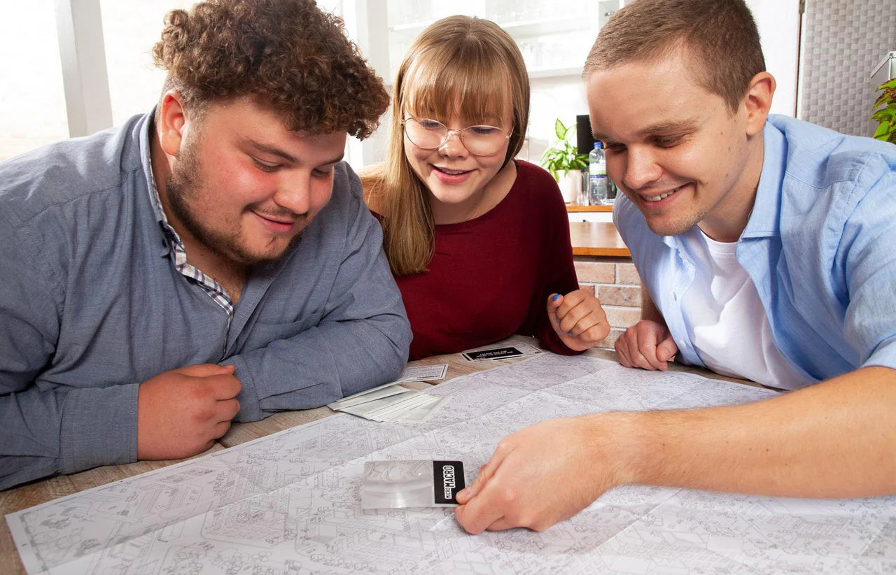 Micromacro Crime City board game being played by three people at a table.