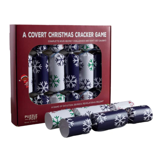 Box of 6 Christmas Crackers for A Covert Christmas Dinner Game by Puzzle Post, with snowflake designs.