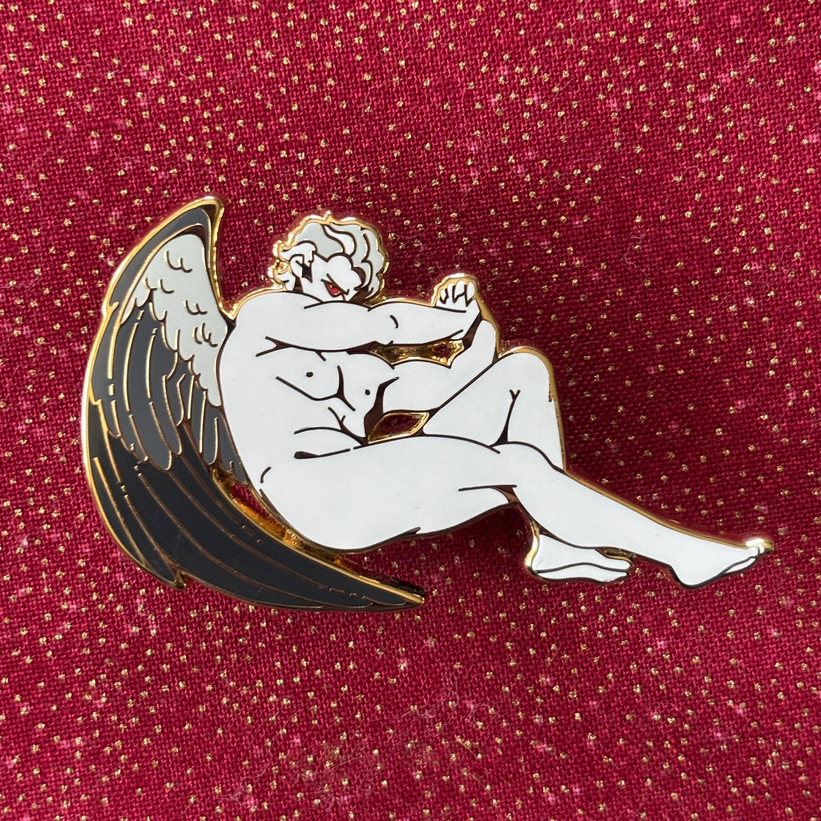 Gold plated Fallen Angel Pin, Astarion Variant, showing a white muscular angel with black wings. Inspired by Cabanel.