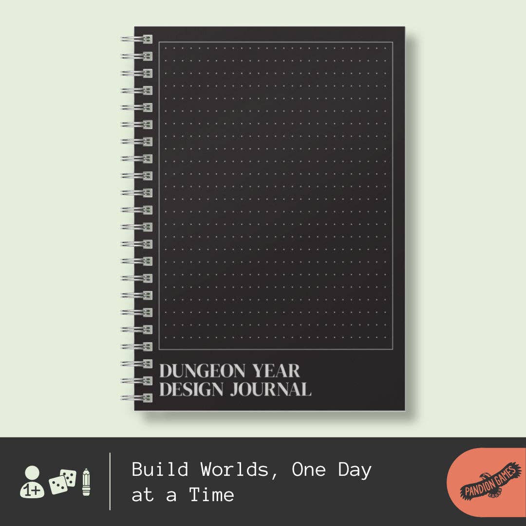 Black spiral-bound Dungeon Year Design Journal with dotted cover and white text at the bottom.