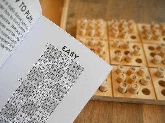 Ecologicals Bamboo Sudoku game shown with an open puzzle book displaying easy sudoku grids.