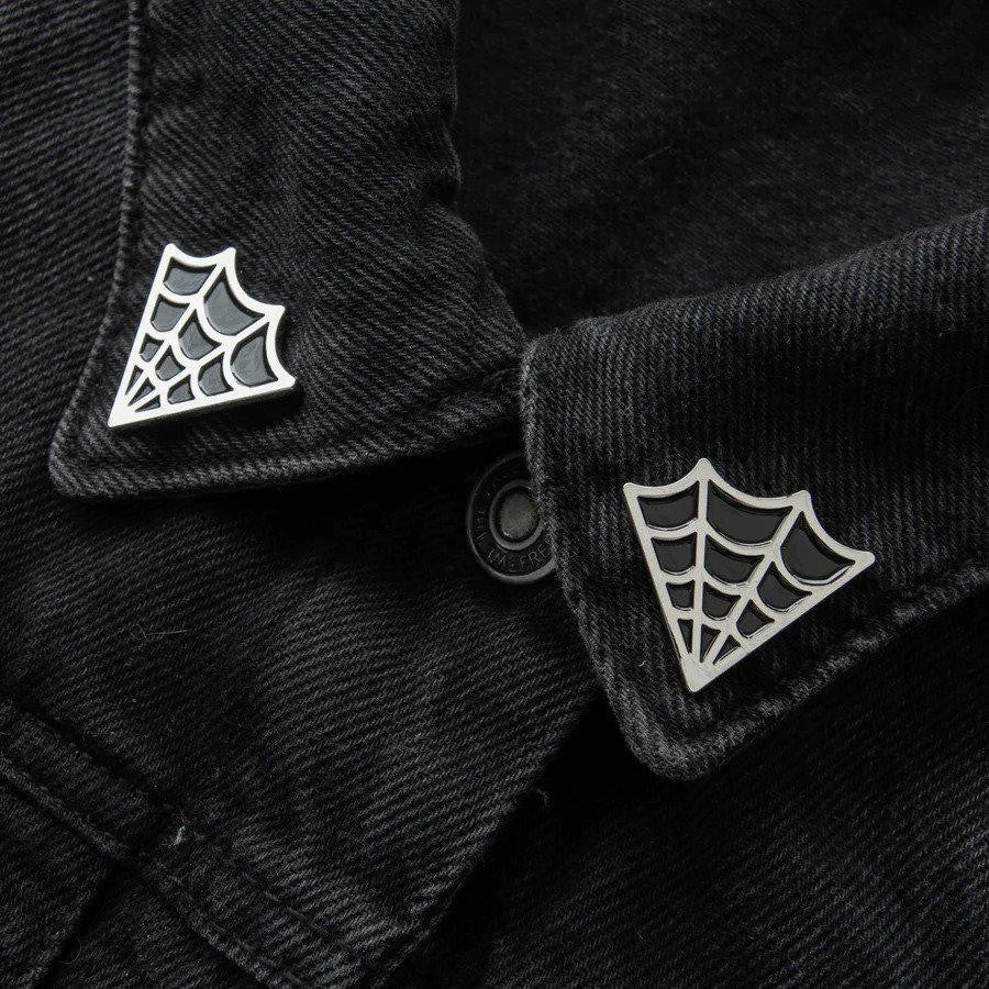 Cobweb Collar Pin Set attached to the collar of a pointed black denim jacket.