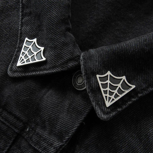 Cobweb Collar Pin Set attached to the collar of a pointed black denim jacket.