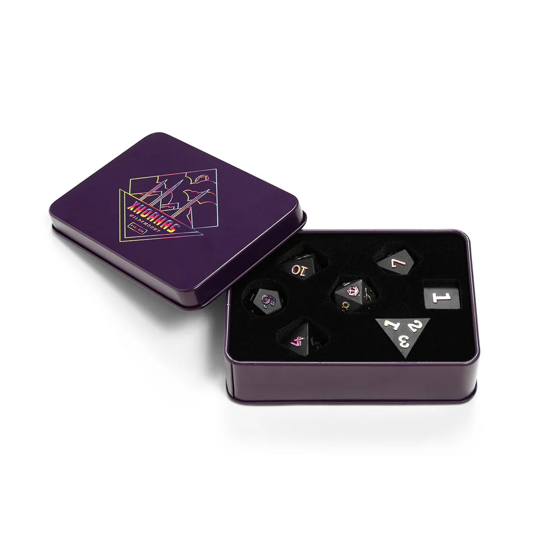 Critical Role Xhorhas Dice Set: black polyhedral dice with white numbers in a partially open purple tin box.