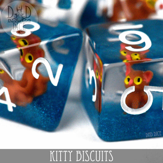 Blue resin dice set with tiny orange cats inside and white numbers; 7 polyhedral dice for DnD.