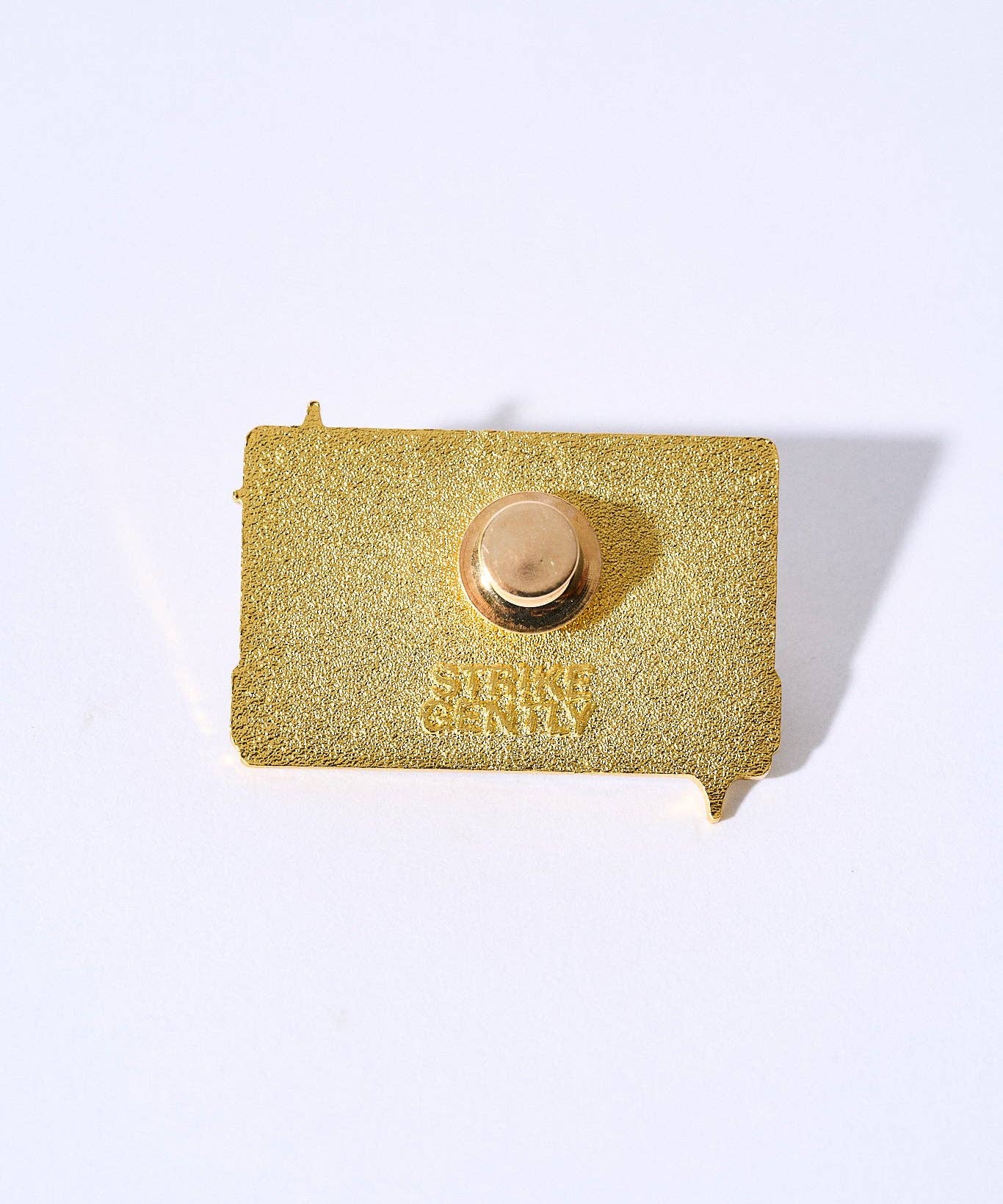 Gold-plated Sad Songs Pin back with embossed text and clasp.