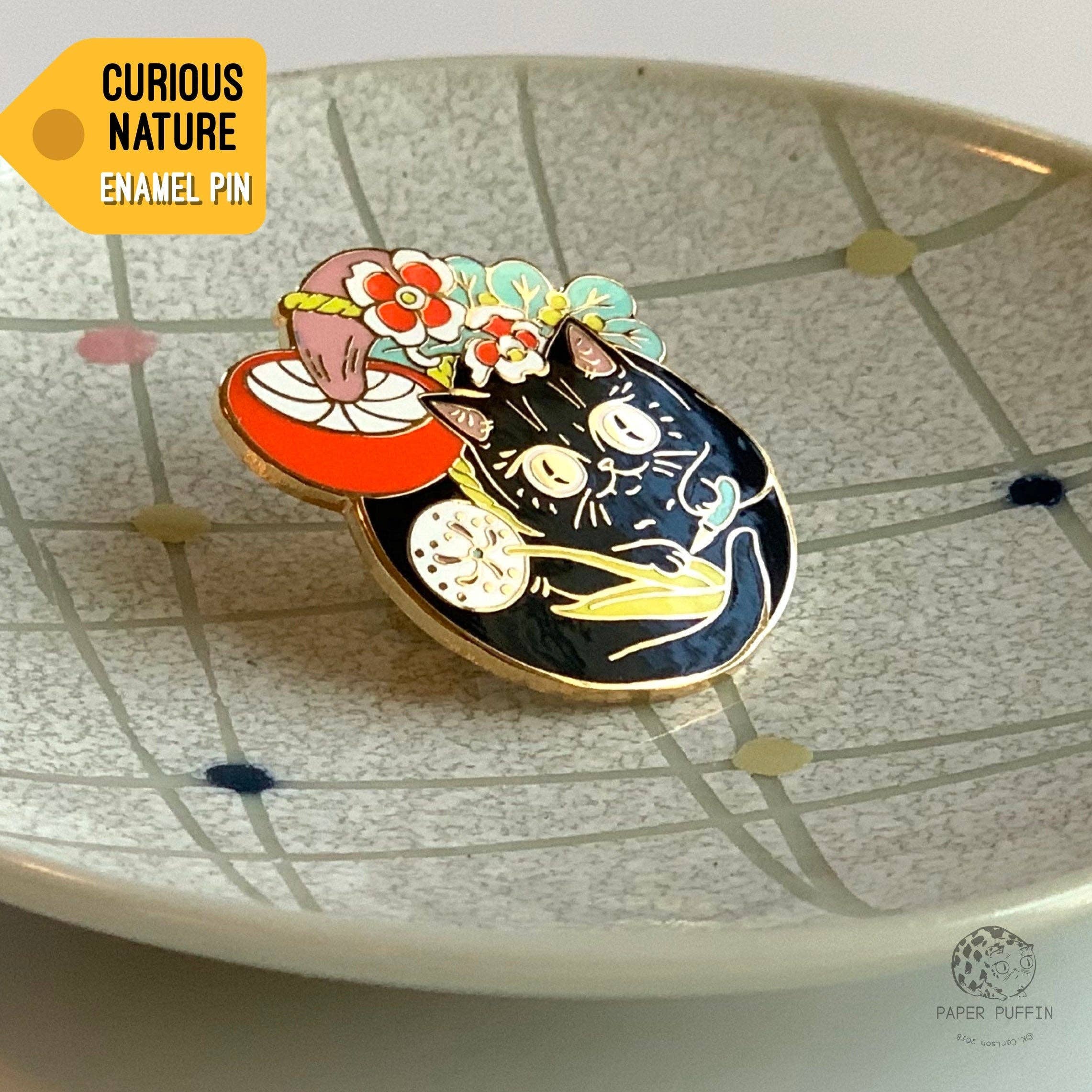 Curious Nature Cat enamel pin: a black cat with a red mushroom and floral accents.