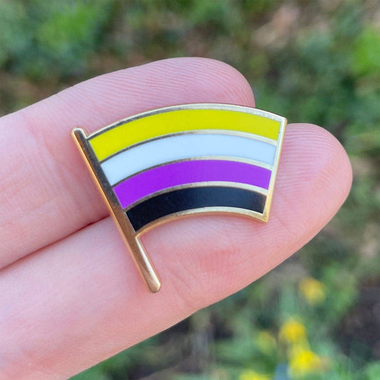 Nonbinary flag enamel pin with yellow, white, purple, and black stripes.