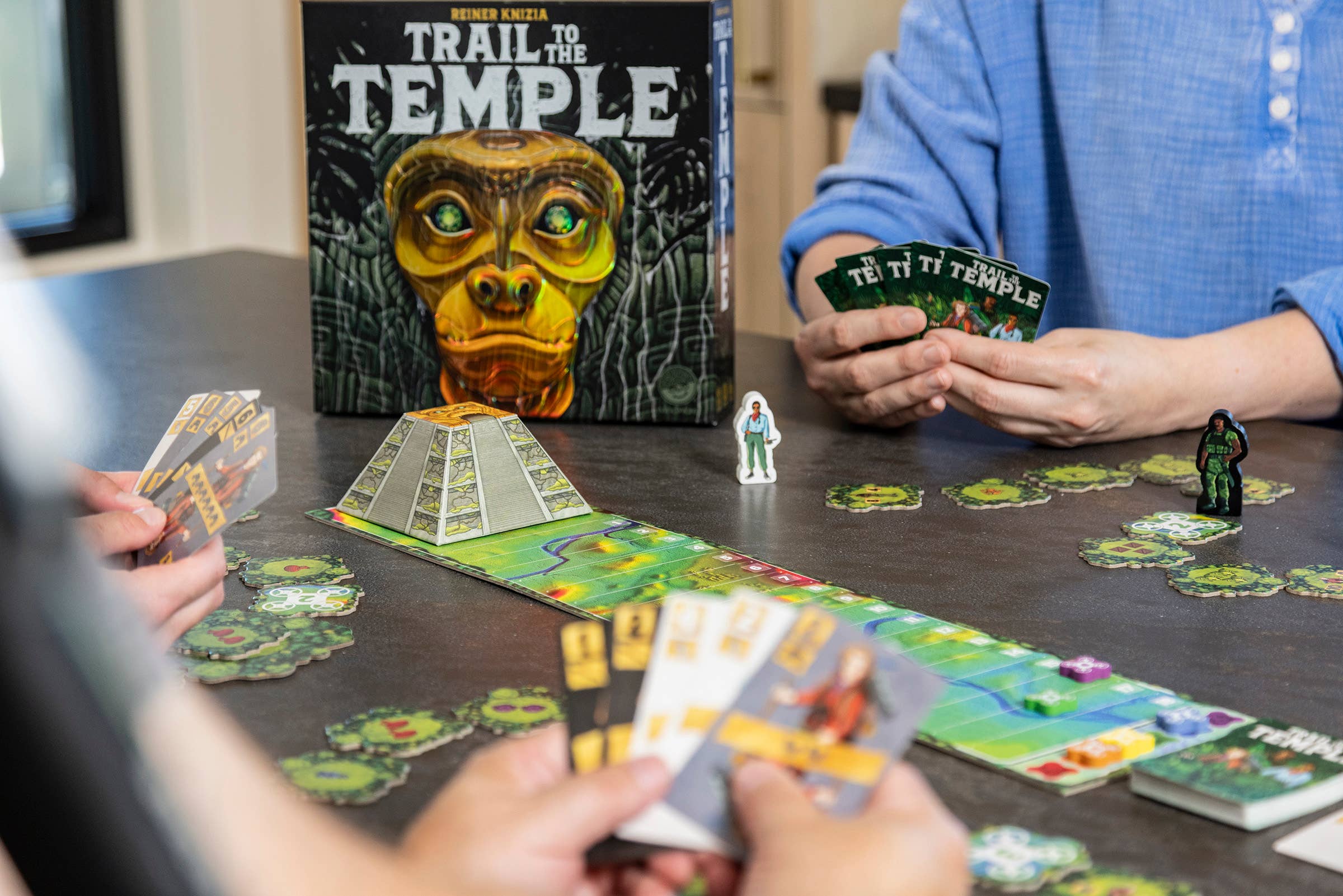 Trail To The Temple board game with cards, tokens, and a pyramid centerpiece.