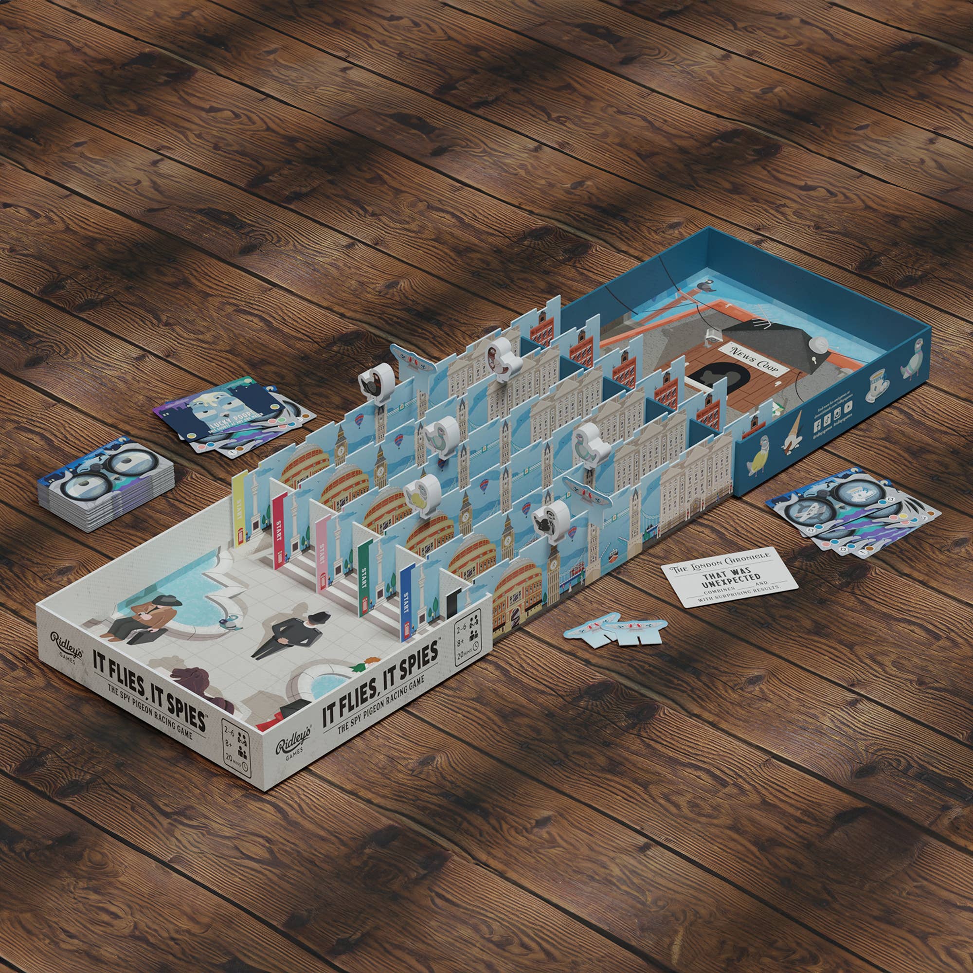 It Flies, It Spies family board game featuring spy pigeon racing gameplay with cards and pathway movement.