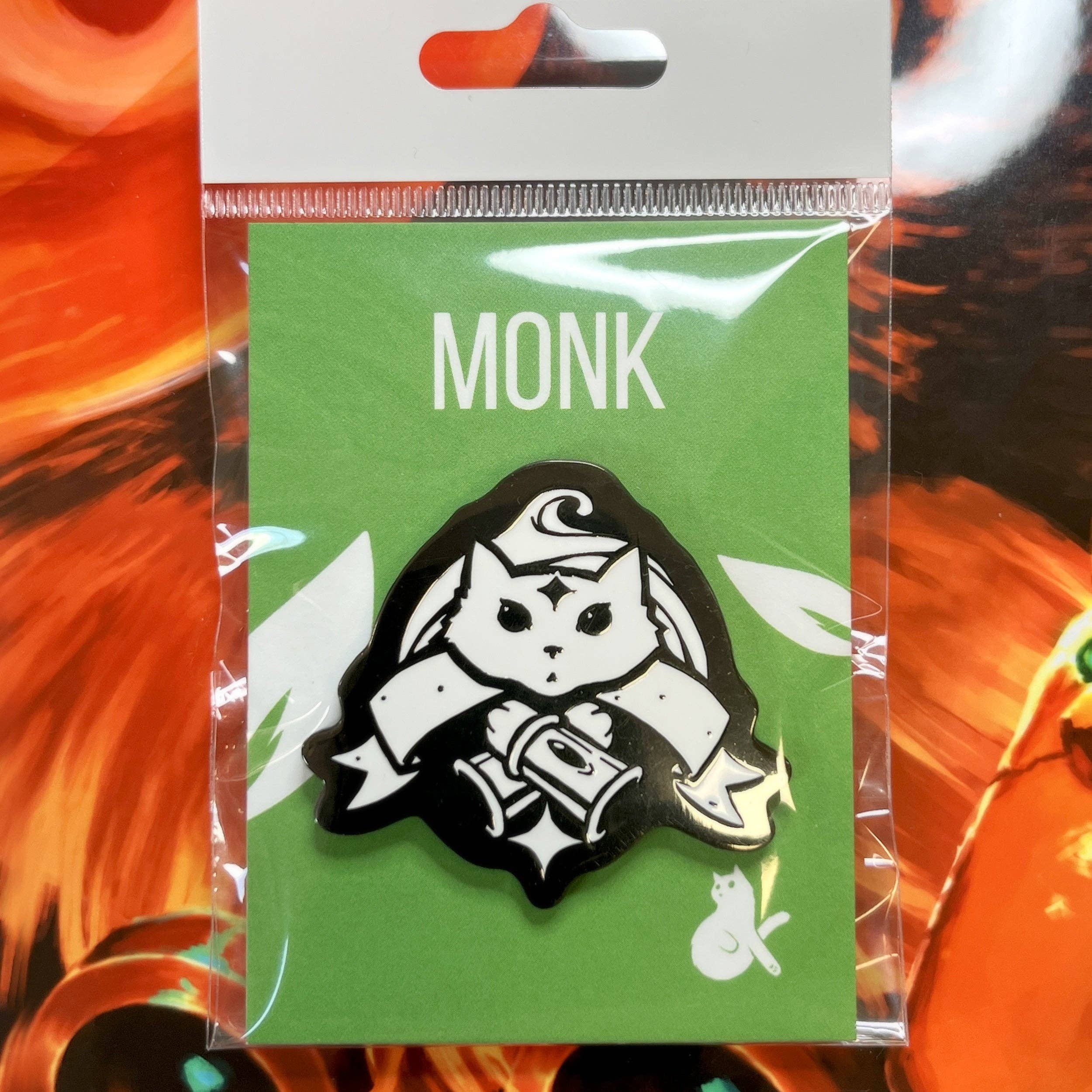 Monk Enamel Pin featuring a white cat in a monk pose, hard enamel style, on green “MONK” backing card.