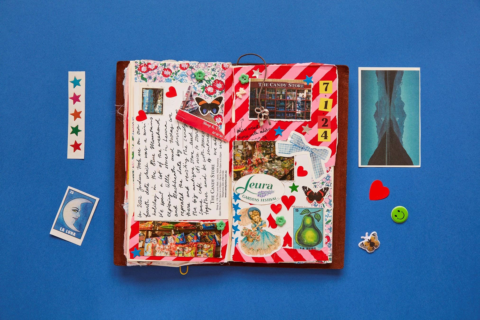 A Year of Junk Journaling book with open pages, handwritten notes, and stickers shown.