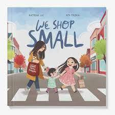 We Shop Small childrens book cover with a woman and two children crossing a street carrying shopping bags.