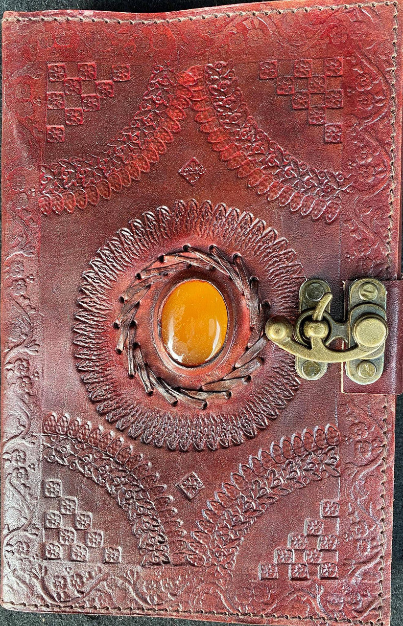 Brown leather journal, 6 x 9, with central gemstone and right-side C lock latch.