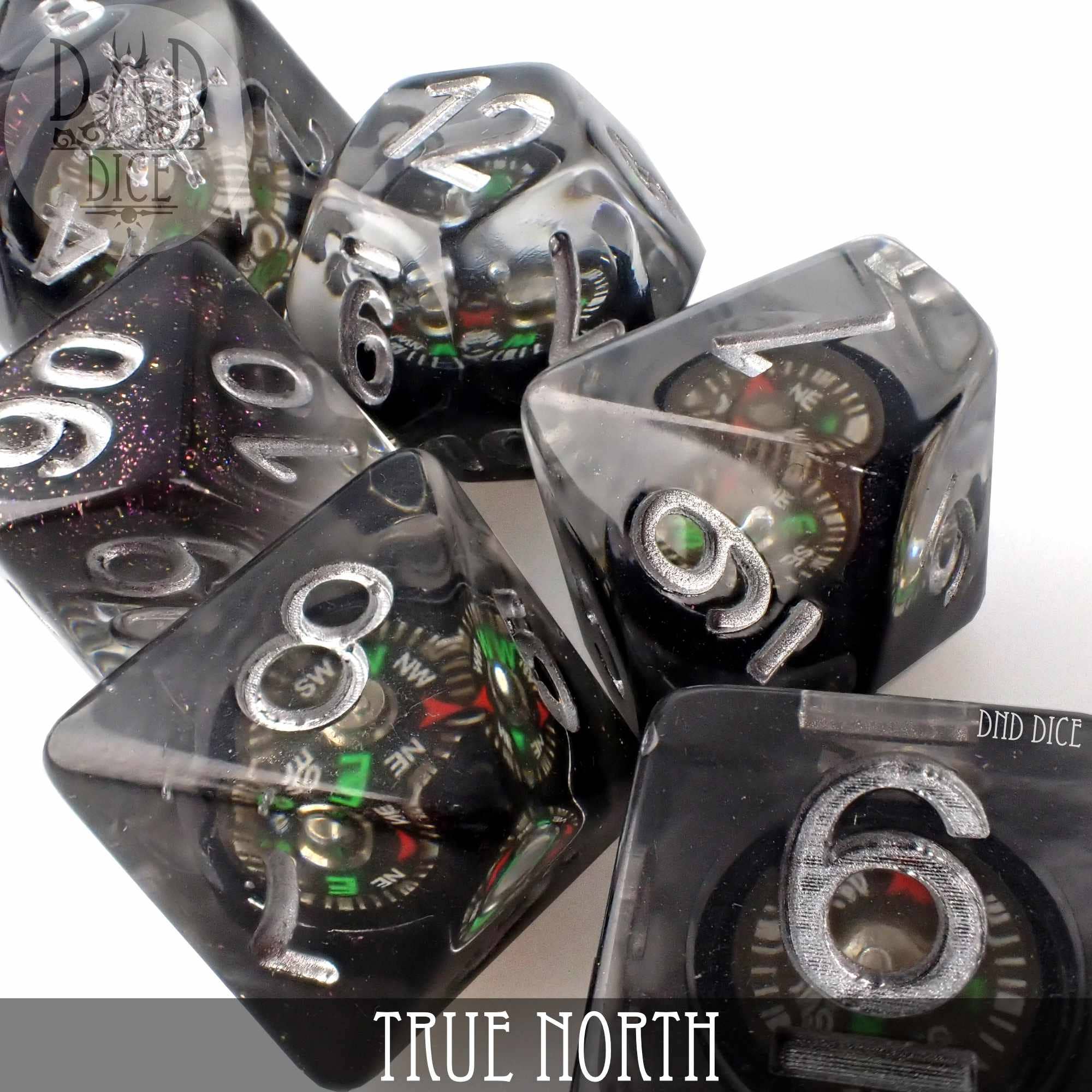 True North 7-piece black resin dice set with a functional compass marked TRUE NORTH on one die.