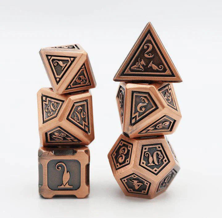 Alchemist Metals RPG Dice Set in copper with engraved numbers and cat image, shown in two stacks.