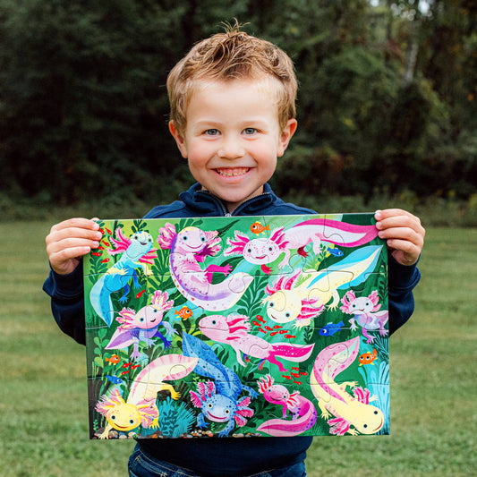 Axolotl 20 Piece Puzzle with jumbo pieces held by a child outdoors.