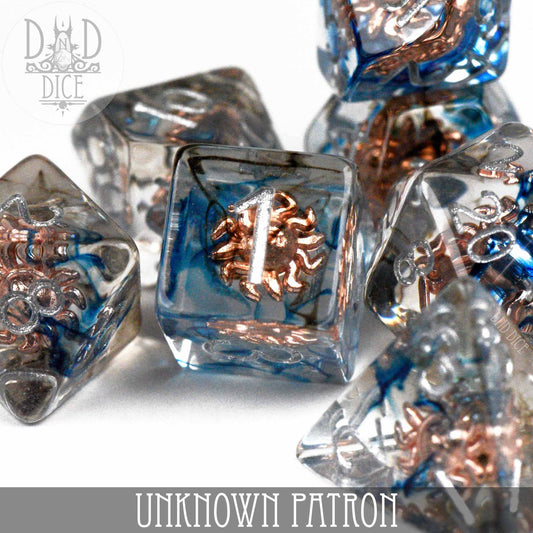 Unknown Patron clear resin 7-dice set with blue wisps and copper details.