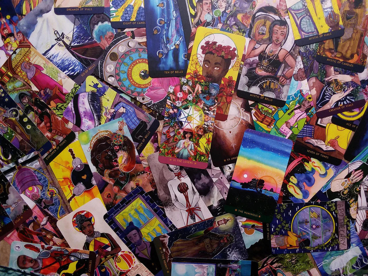 The Numinous Tarot by Cedar McCloud deck with diverse, colorful cards depicting inclusive characters.