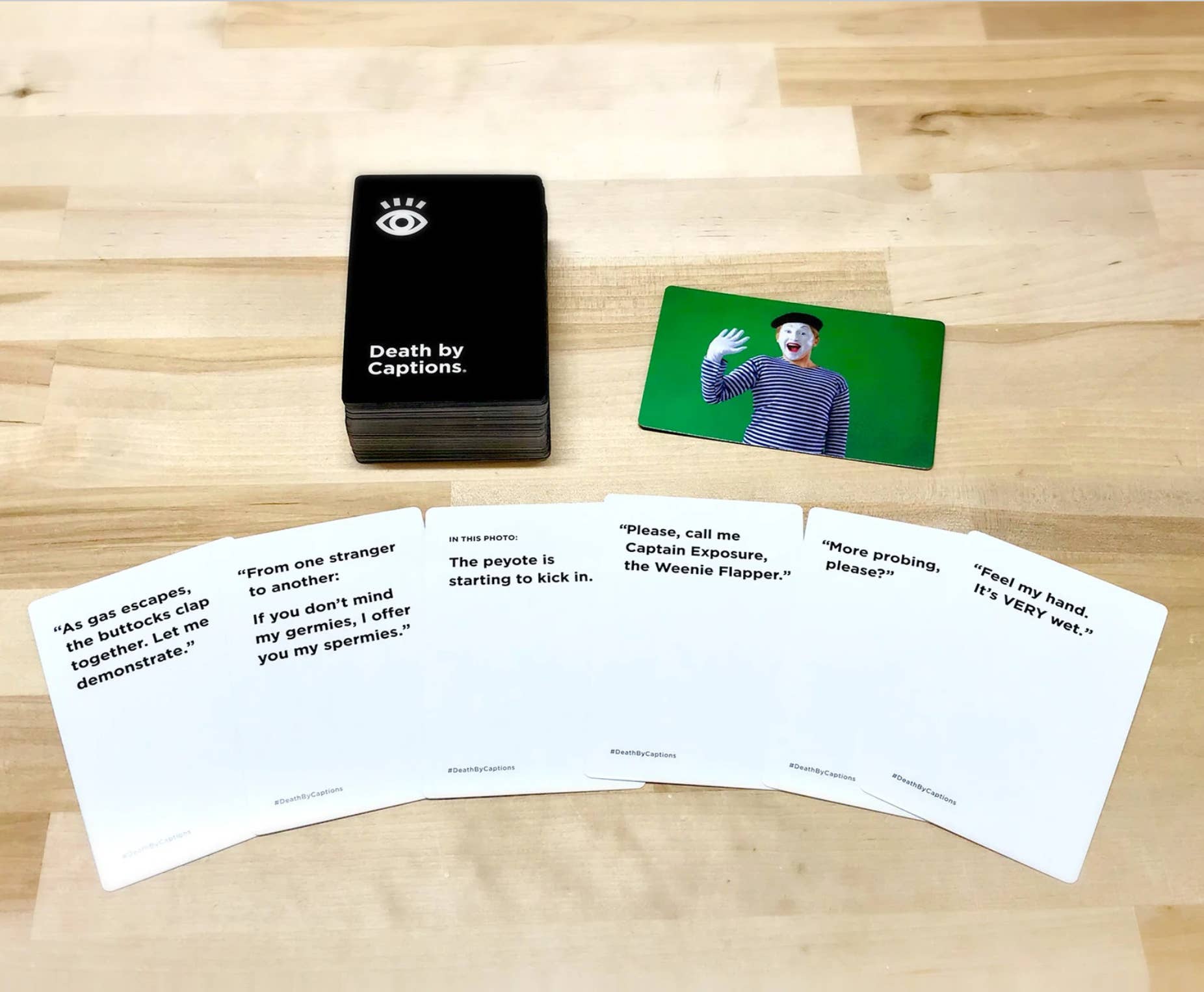 Death by Captions Party Game for adults with spread cards and a mime card shown.