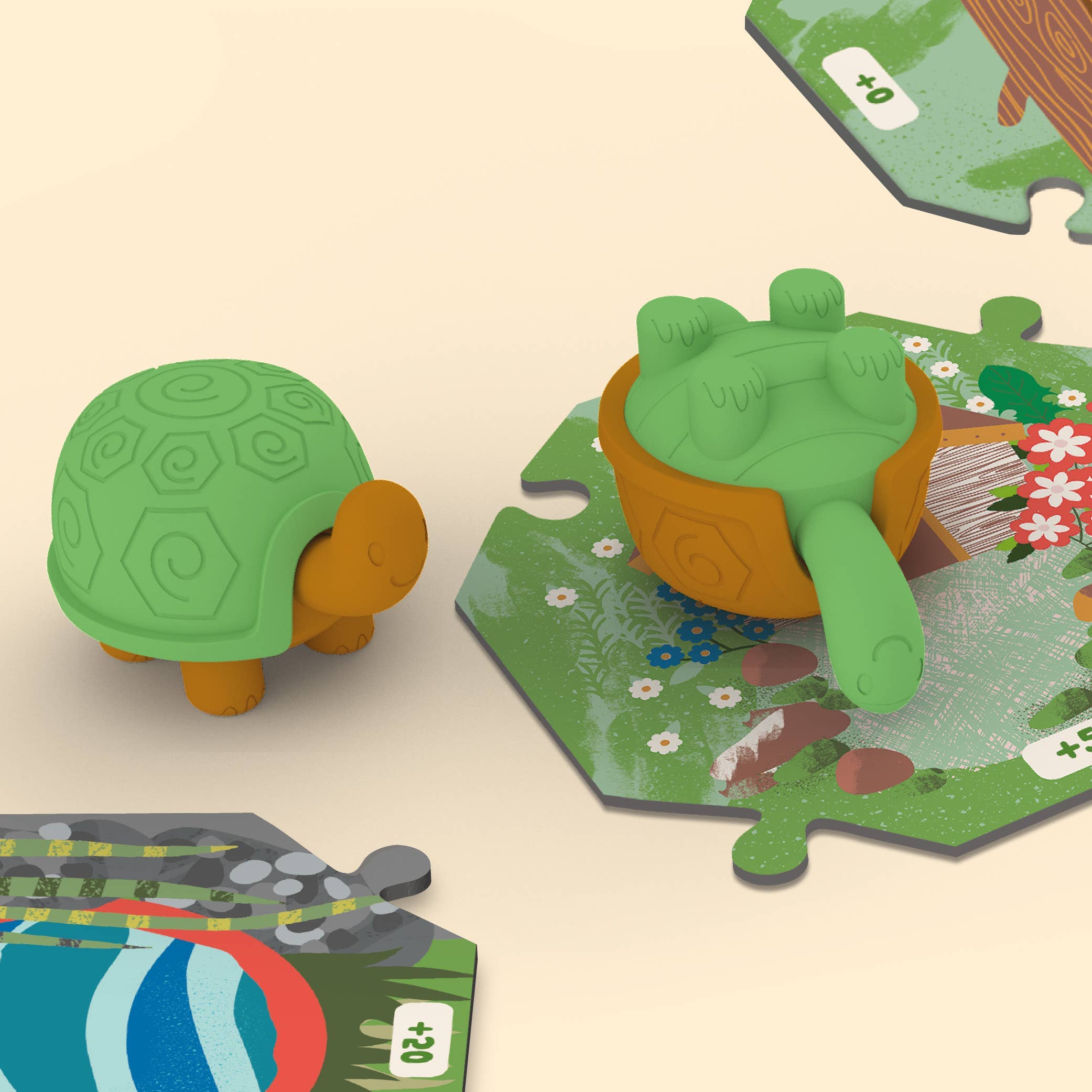 Two Tortoise Tumble toy turtles, one upright and one upside down, on nature puzzle pieces.