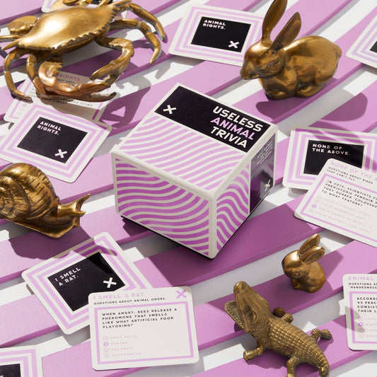 Brass Monkey Useless Animal Trivia cube with animal figurines and trivia cards.
