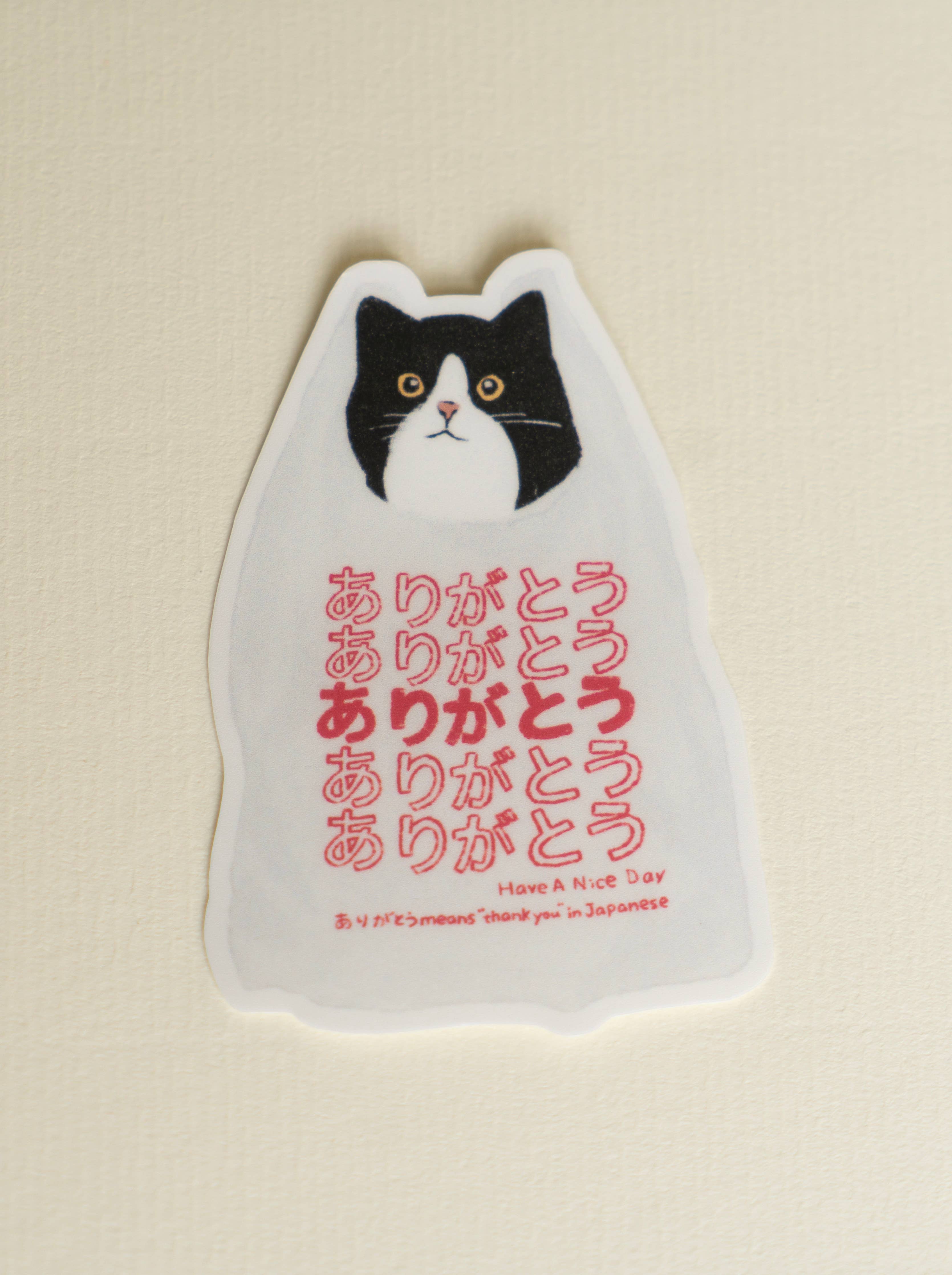 Water-resistant sticker featuring a cat and the Japanese word “Arigatou” (thank you).
