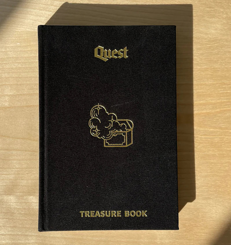 Quest Roleplaying Game Treasure Book with black cover and gold treasure chest design.