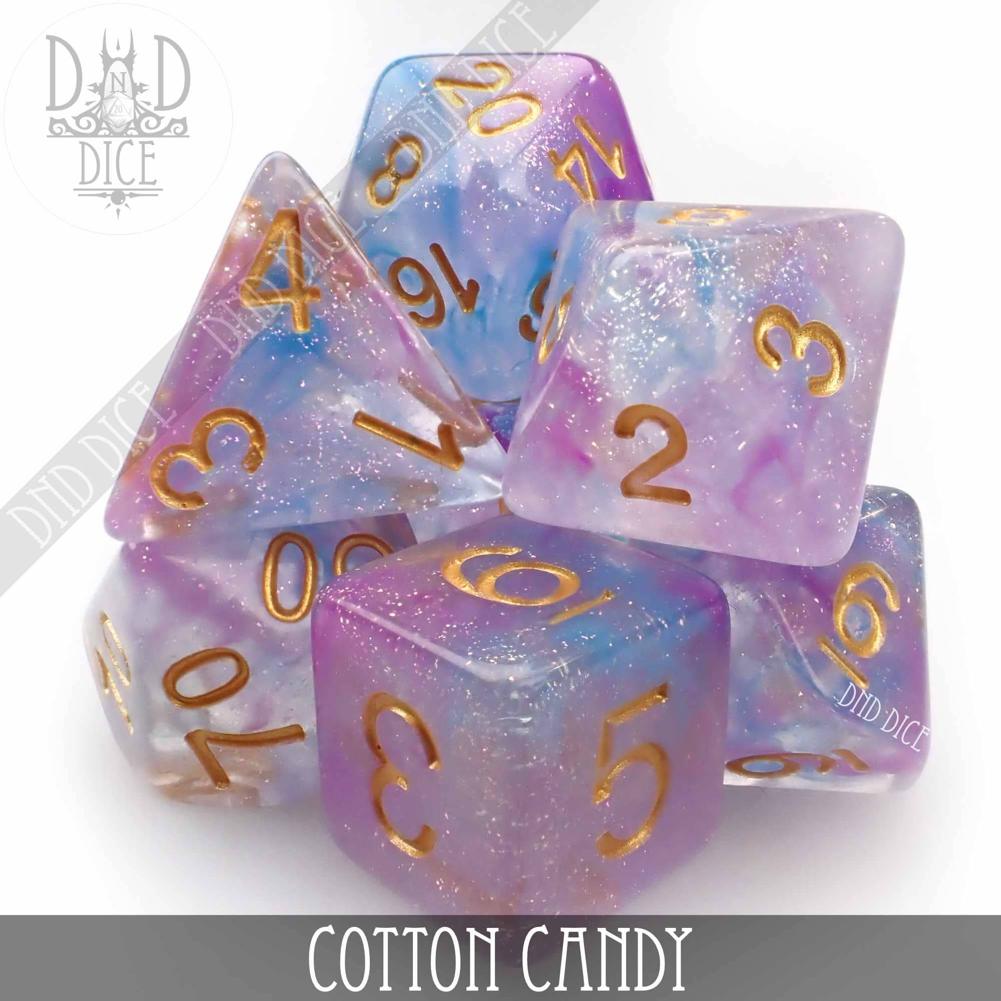 Cotton Candy 7-dice set in pastel blue and pink glitter resin with gold numbers.