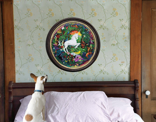Unicorn Garden 500 Piece Round Puzzle displayed above a bed, with a dog looking up at it.