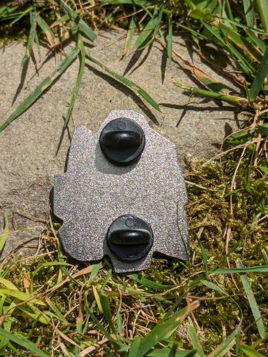 The Cat Amongst Dice 1.5 hard enamel pin with two black clasps.